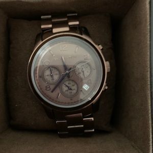 A brown MK 5492 watch